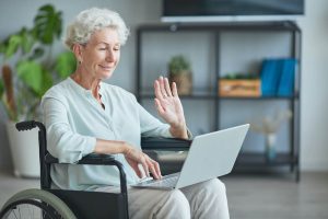 senior woman in wheelchair using video chat