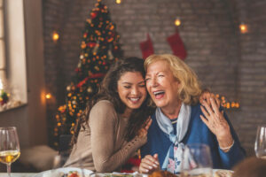 mother and daughter hugging over christmas dinner